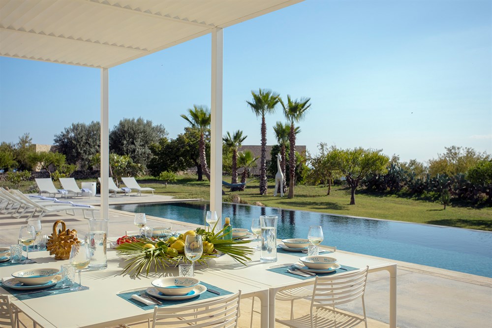 Outdoor dining by the private pool at Villa Agata